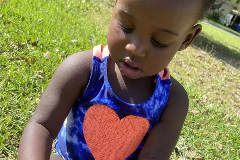 Child focused on something on the ground and not looking at camera